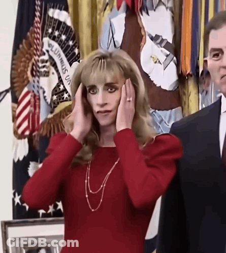 Woman Covering Ears In Front Of Unum Flag GIF
