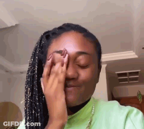 Woman Covering Eyes In Green Shirt GIF