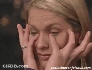 Woman Covering Eyes Looking At Camera GIF