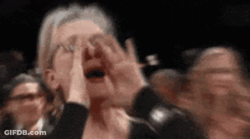 Woman Covering Face In Crowd GIF