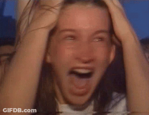 Woman Covering Face In Front Of Crowd GIF
