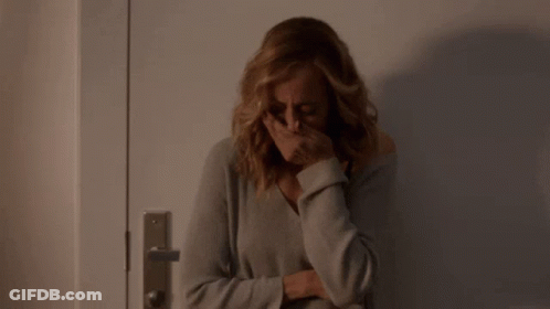 Woman Covering Face In Front Of Door GIF
