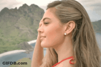 Woman Covering Face In Front Of Mountains GIF