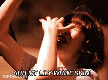 Woman Covering Face Saying Ahh My Lily-White Skin GIF