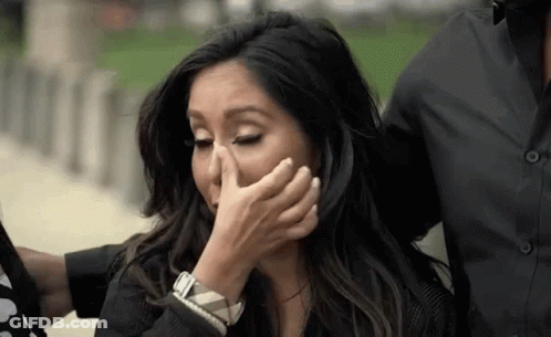 Woman Covering Face While Man Holds Her GIF