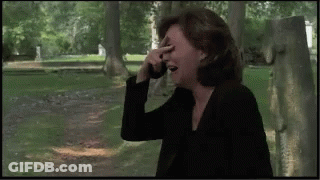 Woman Covering Face While Talking On Cell Phone GIF