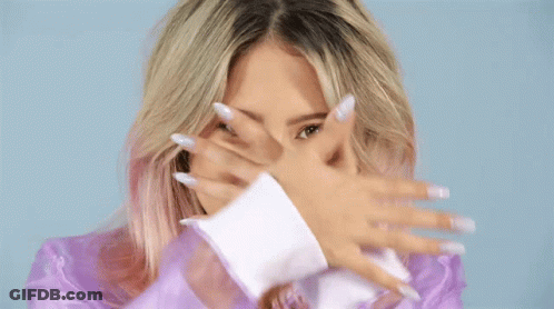 Woman Covering Face With Blue Circle Behind Her GIF