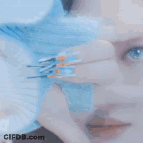 Woman Covering Face With Blue Glove GIF