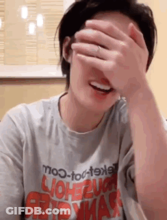 Woman Covering Face With Hand In Mo-To-T9xl Shirt GIF