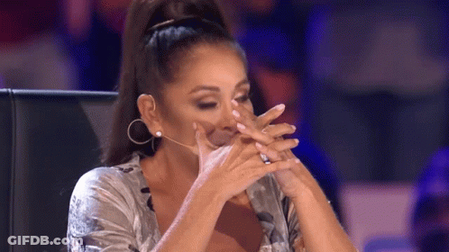 Woman Covering Face With Hands At Microphone GIF