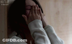 Woman Covering Face With Hands In Sweater GIF