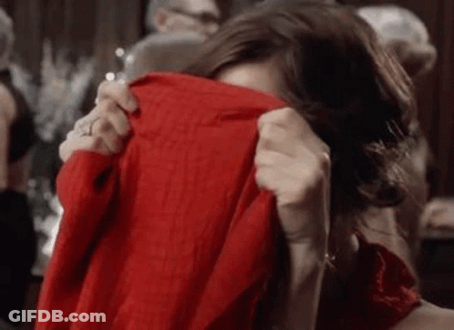 Woman Covering Face With Red Sweater GIF