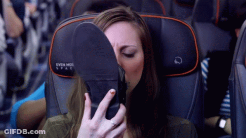 Woman Covering Face With Shoe On Airplane Seat Saying Even More Spac GIF
