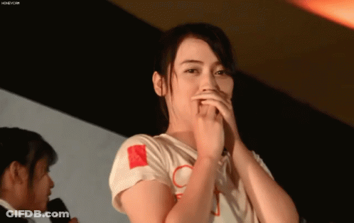 Woman Covering Mouth At Table GIF