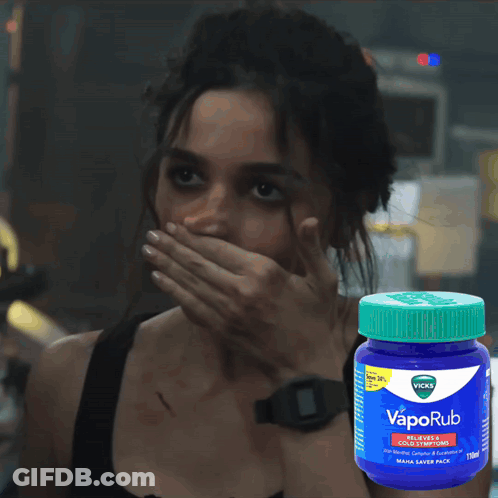 Woman Covering Mouth Beside VapoRub Bottle GIF