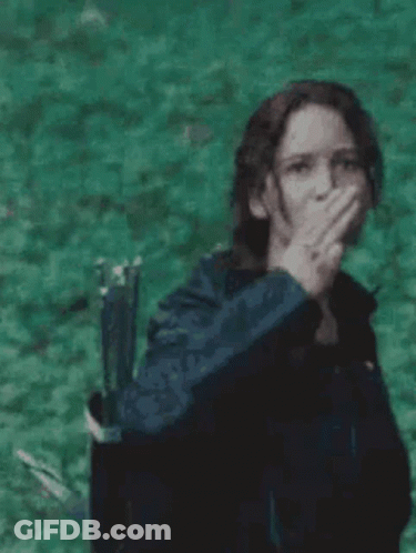 Woman Covering Mouth Holding Bow And Arrow GIF