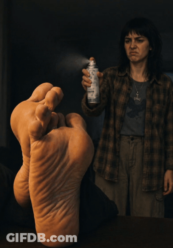 Woman Covering Mouth Holding Spray Can GIF