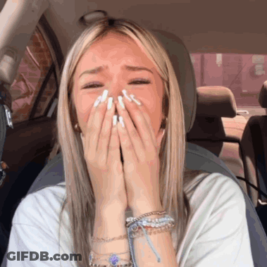 Woman Covering Mouth In Car GIF