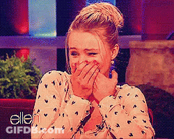 Woman Covering Mouth In Front Of Ellen Sign GIF