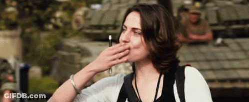 Woman Covering Mouth In Front Of Military Vehicle GIF