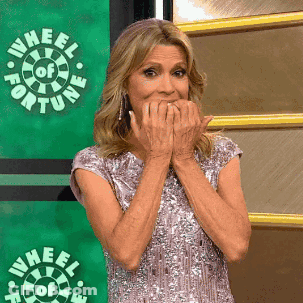 Woman Covering Mouth In Front Of Wheel Of Fortune Logo GIF