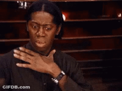 Woman Covering Mouth In Front Of Wooden Wall GIF