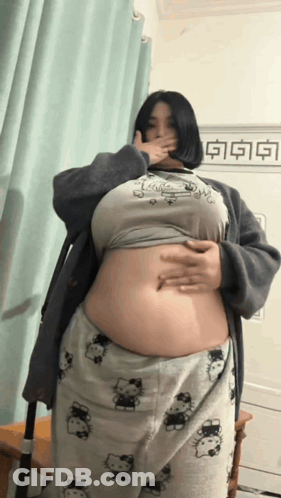 Woman Covering Mouth In Hello Kitty Shirt And Pajamas GIF
