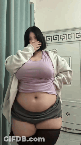 Woman Covering Mouth In Purple Top GIF