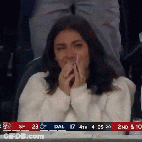 Woman Covering Mouth In Stadium GIF