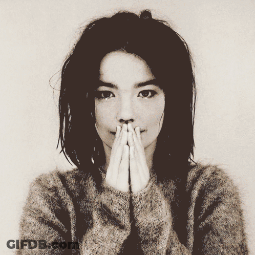 Woman Covering Mouth Looking At Camera GIF