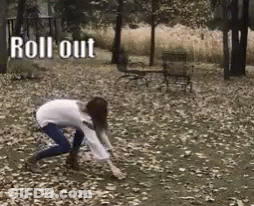 Woman Crawling Through Leaves With Shovel GIF