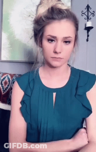 Woman Crossed Arms Wearing Teal Top GIF