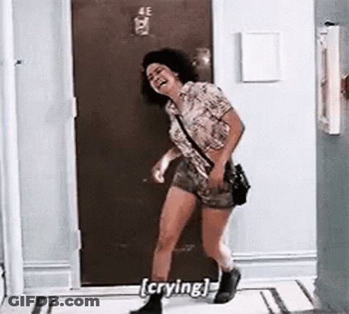 Woman Crying And Laughing In Hallway GIF