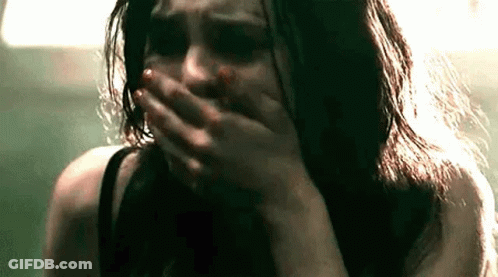 Woman Crying Blood On Face Covering Mouth GIF