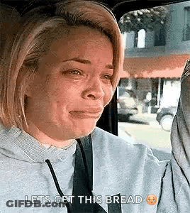 Woman Crying In Car Holding Bread GIF