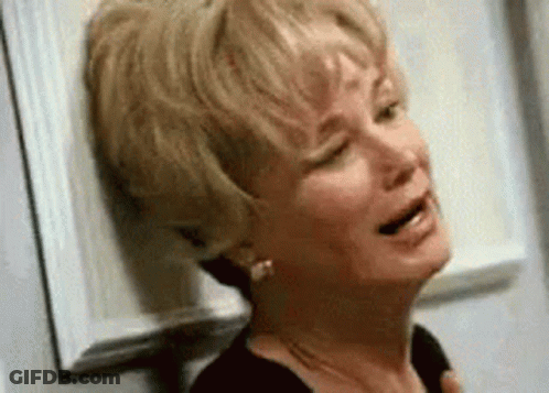 Woman Crying Leaning Against Wall With Eyes Closed GIF