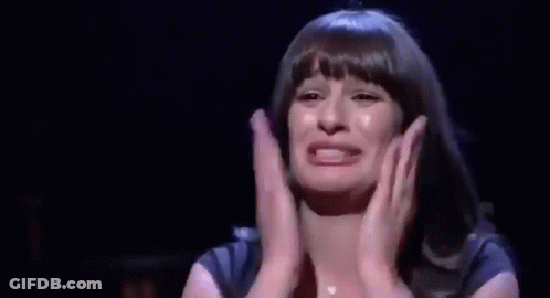 Woman Crying On Stage With Hands Folded GIF