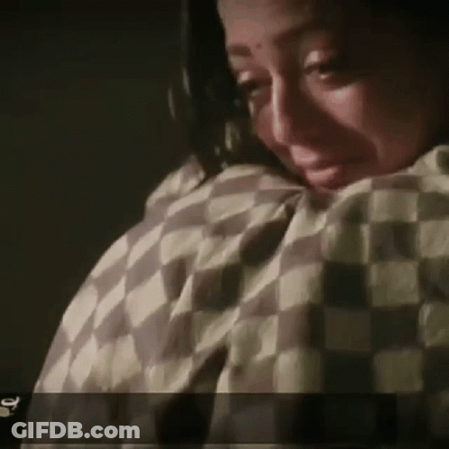 Woman Crying With Checkered Blanket GIF