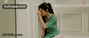Woman Crying With Head In Hands On Bed GIF