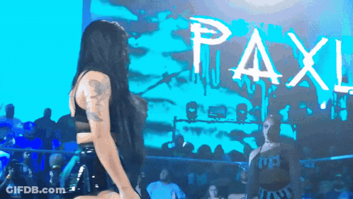 Woman Dances By Sign Saying Paxl GIF