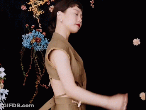 Woman Dancing Among Flowers GIF