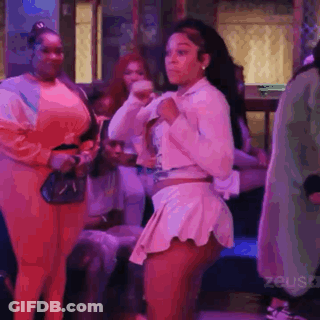 Woman Dancing In A Club With People Standing Around GIF