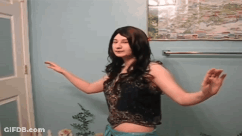 Woman Dancing In Front Of Blue Wall GIF