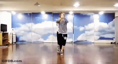 Woman Dancing In Front Of Cloud Wall GIF