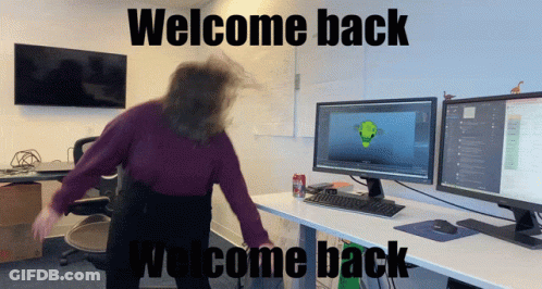 Woman Dancing In Front Of Computer Monitors Saying Welcome Back GIF