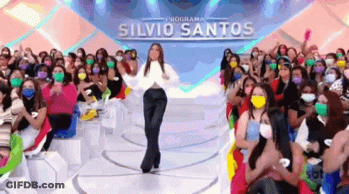 Woman Dancing In Front Of Crowd Wearing Face Masks GIF