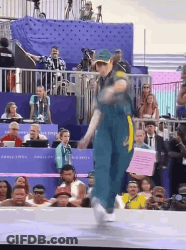 Woman Dancing In Front Of Crowd With Paris 2024 Sign GIF