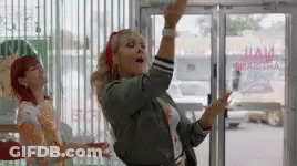 Woman Dancing In Front Of Glass Door GIF