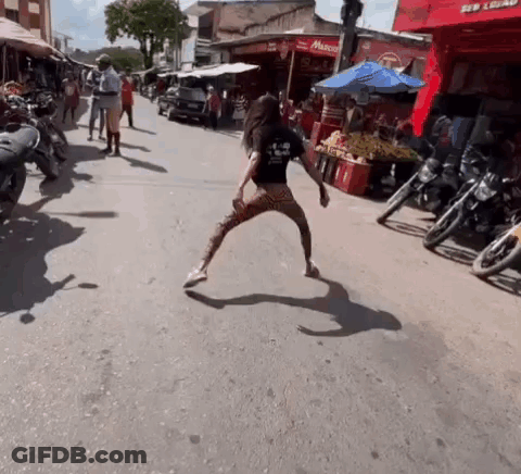 Woman Dancing In Front Of Motorcycles GIF