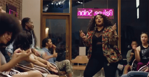 Woman Dancing In Front Of Neon Sign Saying Ndb2 GIF